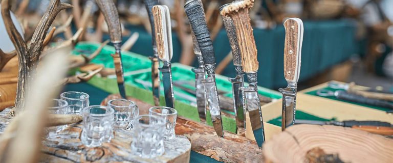 Traditional Craftsmanship: Knives with Staghorn Handles and Glasses on a Stand.